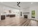 Open floor plan with living room, kitchen, and dining area, featuring modern appliances and fireplace at 310 Pilot Ridge Rd, Zebulon, NC 27597