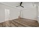 Bright main bedroom features a tray ceiling, fan, wood plank floors and an ensuite bath at 310 Pilot Ridge Rd, Zebulon, NC 27597