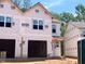Image of new construction home with unfinished exterior, two-car garage, visible windows, and wild logo at 33 Calluna Dr, Clayton, NC 27520
