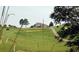 Scenic golf course view featuring rolling hills, lush greenery, and a distant home at 33 Calluna Dr, Clayton, NC 27520