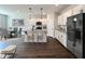 Modern kitchen with white cabinets, granite countertops, stainless steel appliances, and kitchen island at 33 Calluna Dr, Clayton, NC 27520
