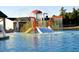 Fun splash pad area at community pool featuring slide, spraying water, and colorful design at 33 Calluna Dr, Clayton, NC 27520