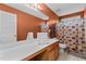 Orange bathroom with white vanity, tub shower, and tiled floors at 338 Howland Ct, Creedmoor, NC 27522