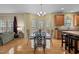Bright dining room features a glass table, modern chairs, and access to the outside deck at 338 Howland Ct, Creedmoor, NC 27522