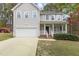 Charming two-story home with a white picket porch, attached garage, and manicured lawn at 338 Howland Ct, Creedmoor, NC 27522