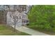 Two-story home features solar panels and a charming front porch surrounded by trees at 338 Howland Ct, Creedmoor, NC 27522