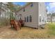 Exterior view showcasing a well-maintained backyard and a wooden deck extending from the side of the house at 338 Howland Ct, Creedmoor, NC 27522