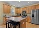 Well-lit kitchen boasts stainless steel appliances, custom cabinetry, and a convenient center island at 338 Howland Ct, Creedmoor, NC 27522