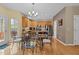 Open kitchen and dining area features wood floors, stainless steel appliances, and custom cabinetry at 338 Howland Ct, Creedmoor, NC 27522