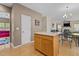 Open-concept layout features a kitchen island connecting to a living area with fireplace and neutral decor at 338 Howland Ct, Creedmoor, NC 27522