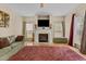 Inviting living room features a cozy fireplace, built-in shelving, and natural light from multiple windows at 338 Howland Ct, Creedmoor, NC 27522