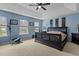 Spacious main bedroom with tray ceiling, fan, plush carpeting, and natural light at 338 Howland Ct, Creedmoor, NC 27522