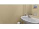 Compact powder room with a pedestal sink, light paint color, and essential fixtures at 338 Howland Ct, Creedmoor, NC 27522