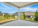 Covered porch with a view of the green backyard at 3510 Tuftonboro Ln, Apex, NC 27502