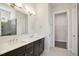 Bathroom with double vanity, dark cabinets and open linen closet at 3510 Tuftonboro Ln, Apex, NC 27502