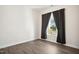 Empty bedroom with wood floor and window with a view at 3510 Tuftonboro Ln, Apex, NC 27502