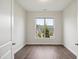 Light-filled bedroom with wood floors and a large window offering natural light and neighborhood views at 3510 Tuftonboro Ln, Apex, NC 27502