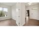 Inviting bedroom with a large window, wood floors, and an open doorway to the rest of the home at 3510 Tuftonboro Ln, Apex, NC 27502