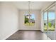 Bright dining area with wood floors, modern chandelier, and sliding doors leading to the outdoors at 3510 Tuftonboro Ln, Apex, NC 27502