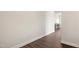 Bright hallway showcasing wood floors that leads to a modern kitchen with an island and pendant lights at 3510 Tuftonboro Ln, Apex, NC 27502