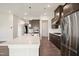 Modern kitchen features stainless appliances, dark cabinets and a large island with sink at 3510 Tuftonboro Ln, Apex, NC 27502