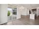 Open living space showcasing wood floors, modern lighting, and access to a covered outdoor living space at 3510 Tuftonboro Ln, Apex, NC 27502