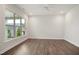 Spacious living room featuring wood floors, recessed lighting, and a large window overlooking the outdoors at 3510 Tuftonboro Ln, Apex, NC 27502