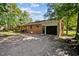 Back of house with a paved driveway leading to the attached garage at 401 Crestview Dr Dr, Durham, NC 27712