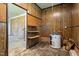 Unfinished basement featuring wood paneled walls, water heater, and shelving for plenty of storage options at 401 Crestview Dr Dr, Durham, NC 27712