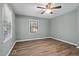 Bedroom with wood floors, a ceiling fan and a large window at 401 Crestview Dr Dr, Durham, NC 27712
