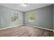 Bedroom with wood-look flooring, neutral paint, and windows with natural light at 401 Crestview Dr Dr, Durham, NC 27712