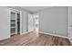 This bedroom includes wood-look flooring, a window, a closet, and a neutral paint at 401 Crestview Dr Dr, Durham, NC 27712