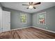 Bedroom features wood-look flooring, ceiling fan, natural light from windows, and closet at 401 Crestview Dr Dr, Durham, NC 27712