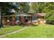 Charming single-story brick home with a well-manicured lawn and mature trees at 401 Crestview Dr Dr, Durham, NC 27712