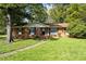 Charming single-story brick home with a well-manicured lawn and mature trees at 401 Crestview Dr Dr, Durham, NC 27712