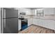Well-lit kitchen with stainless steel appliances, and white cabinets at 401 Crestview Dr Dr, Durham, NC 27712