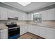 Well-lit kitchen featuring white cabinets and modern appliances at 401 Crestview Dr Dr, Durham, NC 27712