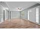 Bright living room features wood-look floors, ceiling fan, neutral paint, and bright windows at 401 Crestview Dr Dr, Durham, NC 27712
