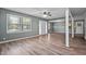 Bright living room features wood-look floors, ceiling fan, neutral paint, and bright windows at 401 Crestview Dr Dr, Durham, NC 27712