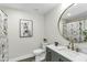 Bathroom features a stylish vanity, a round mirror, and a shower with a curtain at 434 Robin Rd, Chapel Hill, NC 27516