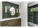 Stunning bathroom features dark green tile, a floating vanity, and a glass-enclosed shower at 434 Robin Rd, Chapel Hill, NC 27516