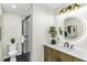 This bathroom features a modern vanity, framed mirror, and a walk-in shower at 434 Robin Rd, Chapel Hill, NC 27516