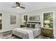 Stylish bedroom with modern decor, ceiling fan, and a view of the green scenery outside at 434 Robin Rd, Chapel Hill, NC 27516