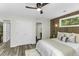 Cozy bedroom features wood accent wall, views, and double door access to closet at 434 Robin Rd, Chapel Hill, NC 27516