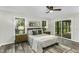 Cozy bedroom with natural light, ceiling fan, and sliding door access to the wooden patio at 434 Robin Rd, Chapel Hill, NC 27516