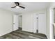 Bedroom with spacious closet, neutral walls, and modern flooring, complemented by a stylish ceiling fan at 434 Robin Rd, Chapel Hill, NC 27516