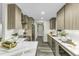 Modern kitchen with stainless steel appliances, sleek cabinets and white countertops at 434 Robin Rd, Chapel Hill, NC 27516