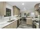 Modern kitchen featuring stainless steel appliances and wood-look cabinets with quartz countertops at 434 Robin Rd, Chapel Hill, NC 27516