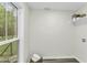 Bright laundry room with window, built-in shelf, and washer/dryer hookups, offering a functional space at 434 Robin Rd, Chapel Hill, NC 27516