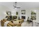 Bright living room featuring a fireplace, ceiling fan, and modern furniture at 434 Robin Rd, Chapel Hill, NC 27516
